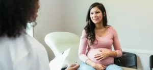 Pregnant Woman Talking To Clinician