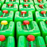 Green Plastic Drums With Chemicals Set In The Square