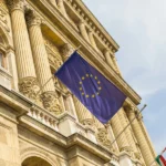 A European Flag Flying In Front Of A Building