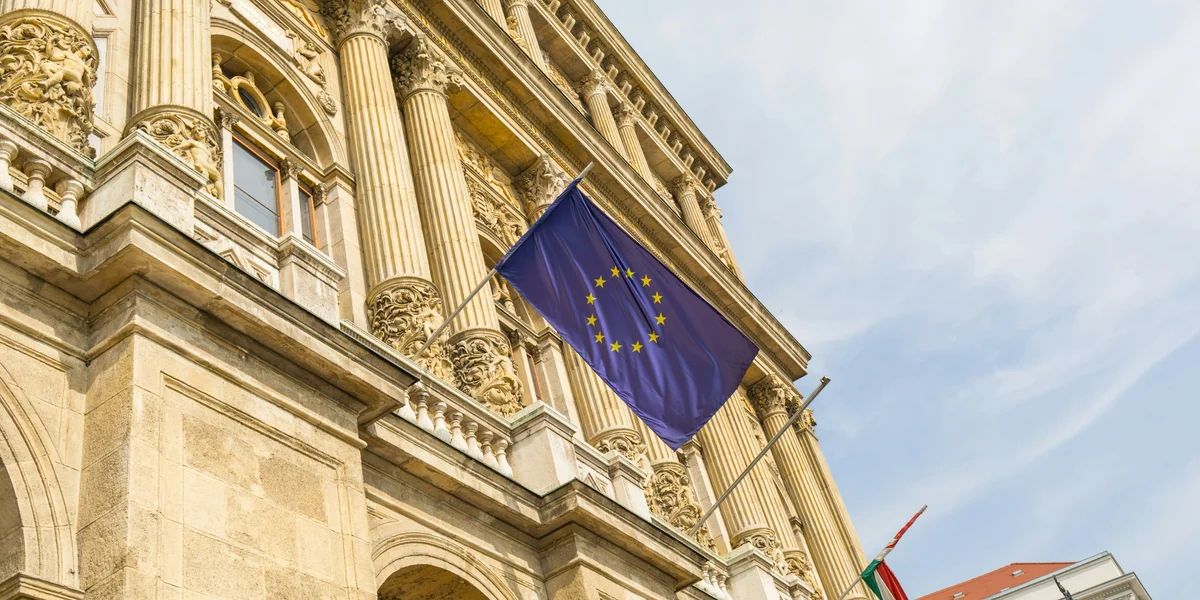 A European Flag Flying In Front Of A Building